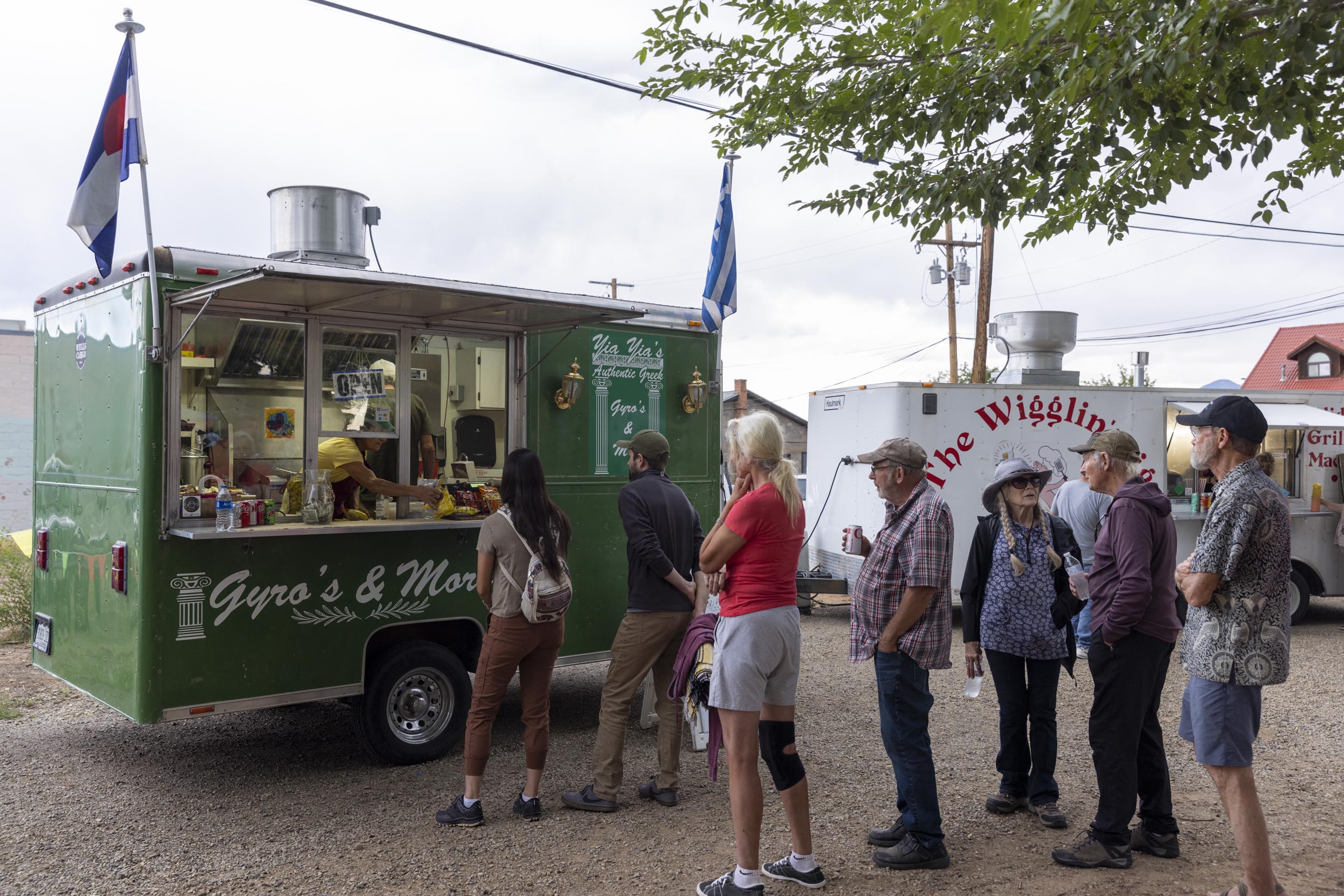Several people stand in line for a food truck at Third Thursdays event in Cortez.