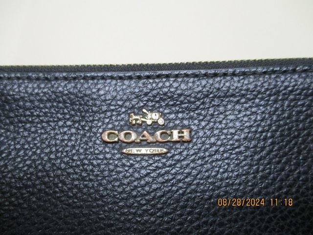 Photo of a navy blue coach handbag